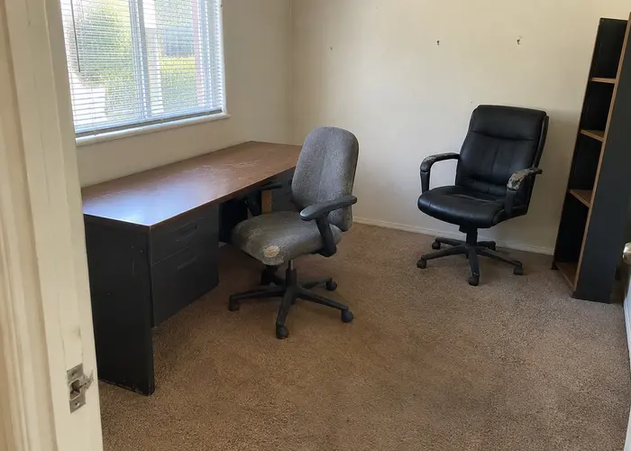 Desk and two office chairs in a room