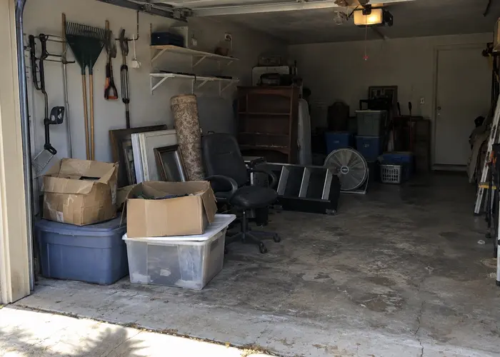 Boxes, bins and furniture stored in an open garage