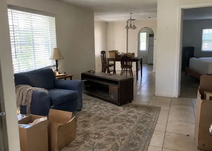 Furniture and cardboard boxes in connected rooms