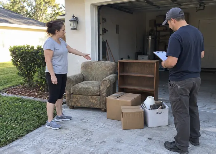 Two people discussing furniture beside an open garage