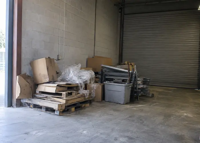 Pallets, packaging and loose shelving beside a roll-up door